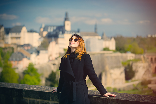 portrait of beautiful young woman relaxing and enjoying a splendid view of town