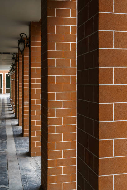 istock Pattern of red brick columns and electrical lamps 680675428