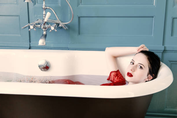 istock young woman in bath with flowers 680676152