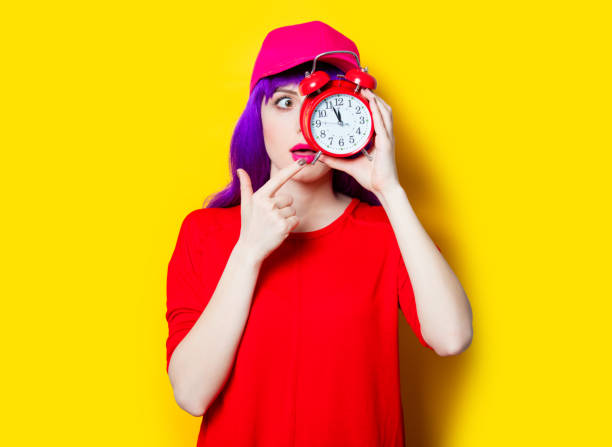 istock young woman with alarm clock 680676728
