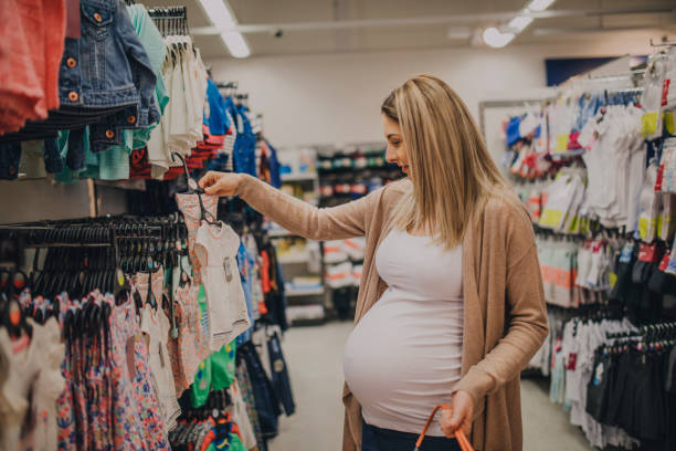 80+ Pregnant Woman Buying Baby Clothes In Supermarket Stock Photos