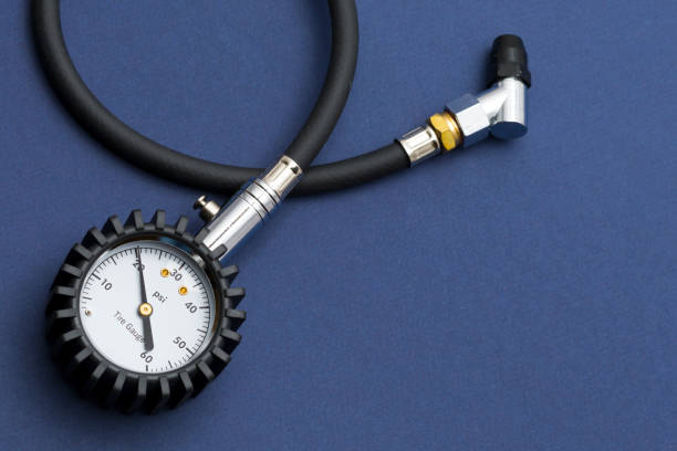 Tire-pressure gauge Tire-pressure gauge on dark blue background. pressure gauge stock pictures, royalty-free photos & images