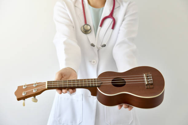 istock Doctor giving ukulele (musical instrument), Music therapy concept. (Selective Focus) 680680856