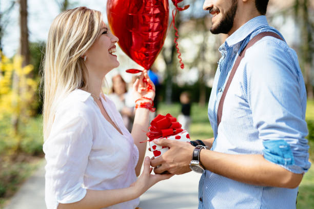 istock Man giving surprise gift as present to his lovely girlfriend 680691530