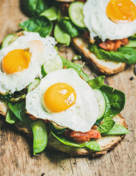 istock Healthy breakfast sandwiches on wooden board background 680692538