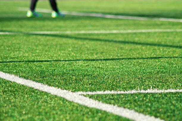 Artificial green grass with white stripe of soccer field