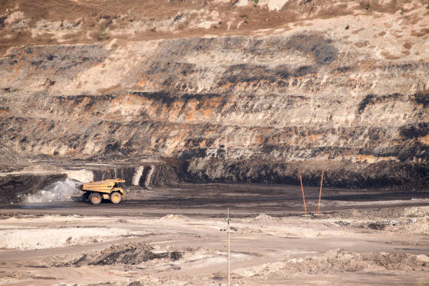 istock Part of a coal mine pit with big mining truck working 680695012
