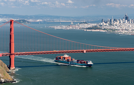 SAN FRANCISCO - APRIL 19: MOL container ship enters San Francisco Bay under Golden Gate Bridge on April 19, 2017. The MOL Guardian is 275m long.