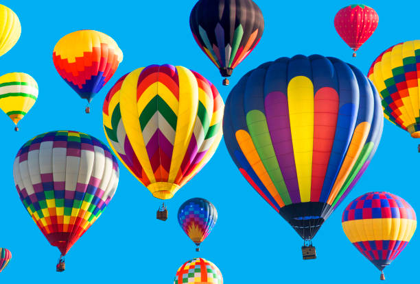 Series: Colorful hot air balloons flying in bright blue sky Brightly colored hot air balloons against blue background. Taken with Canon 5D Mark lll. ballooning festival stock pictures, royalty-free photos & images