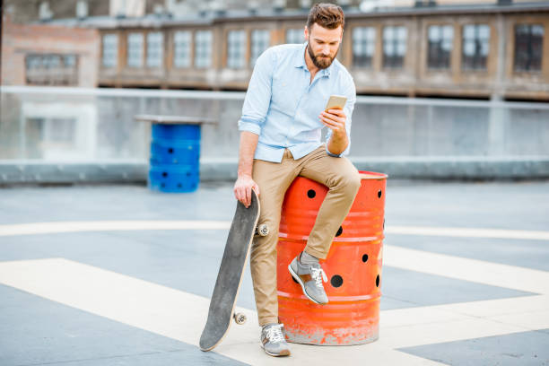 istock Hipster with smartphone on the rooftop 680706990