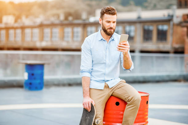 istock Hipster with smartphone on the rooftop 680707034