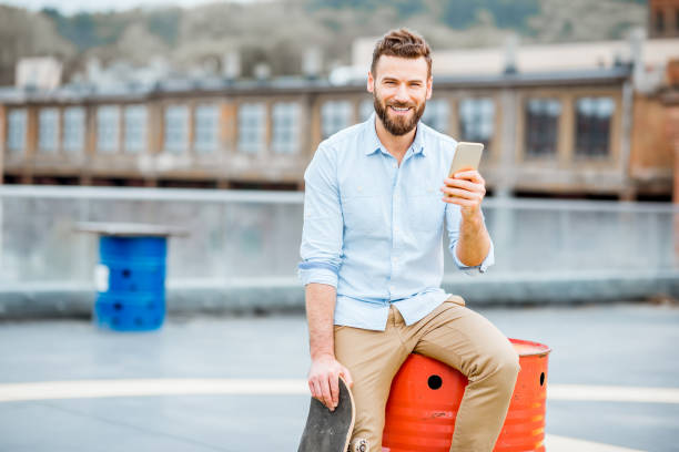 istock Hipster with smartphone on the rooftop 680707072