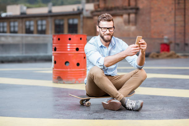Businessman with smart phone on the rooftop