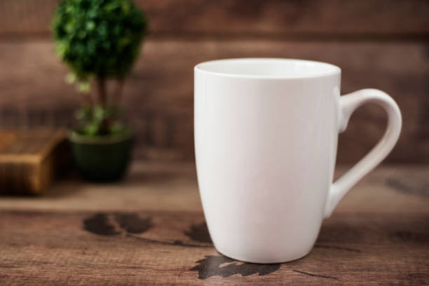 istock Mug Mockup. Coffee Cup Template. Coffee Mug Printing Design Template. White Mug Mockup, Old Book and Flower, Wooden Background. Blank Mug. Mockup Styled Stock Product Image 680711044