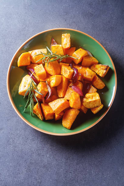 istock Sweet potatoes with onions and rosemary. Dark background. 680714418