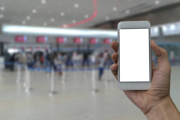 istock Hand holding smartphone with white blank screen over blurred Counter check-in background 680720188