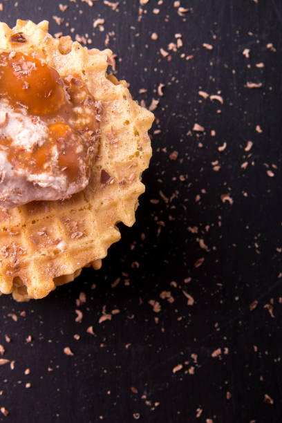 istock Belgian waffle with ice cream and chocolate on black background. Top view. 680721640