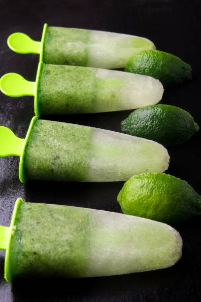istock Green homemade ice cream on black background. Fruit ice with lime. Close up. 680721730