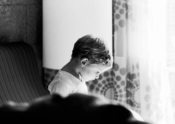 istock Very Grainy black and white image of a thoughtful child 680722594