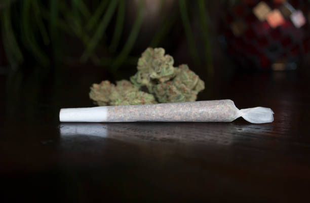 istock nice closeup of rolled marijuana weed joint on wooden background 680734376