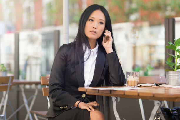 istock Asian middle-aged businesswoman working at a cafe table 680734454