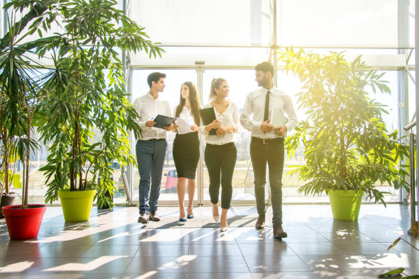 Business partners walking down in office building and talking.