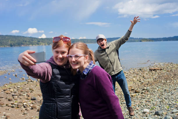 Selfie Gets Photobombed Two friends take a selfie together while getting photobombed. photo bomb stock pictures, royalty-free photos & images
