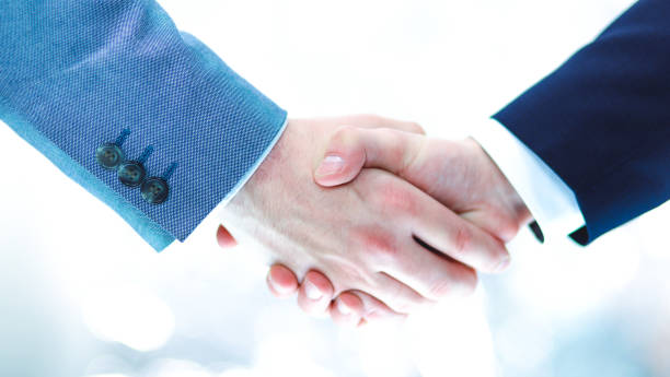 istock Businessmen shaking hands, isolated on white 680746002