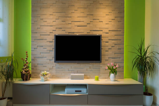 Modern living room interior - tv mounted on brick wall with black screen and ambient light