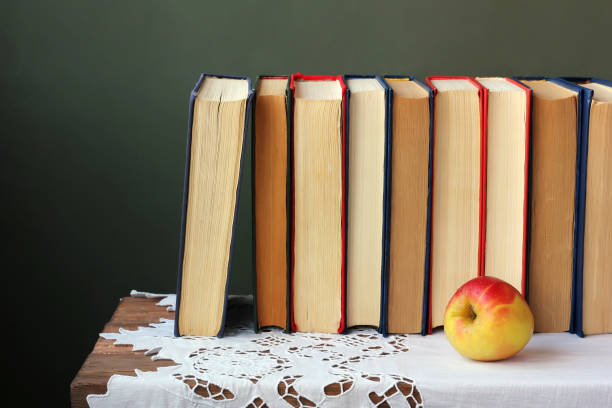 istock Books close up on a table with a white cloth. 680751770