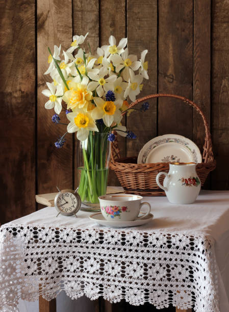 istock Still life with yellow daffodils in a vase in a rustic style 680754248
