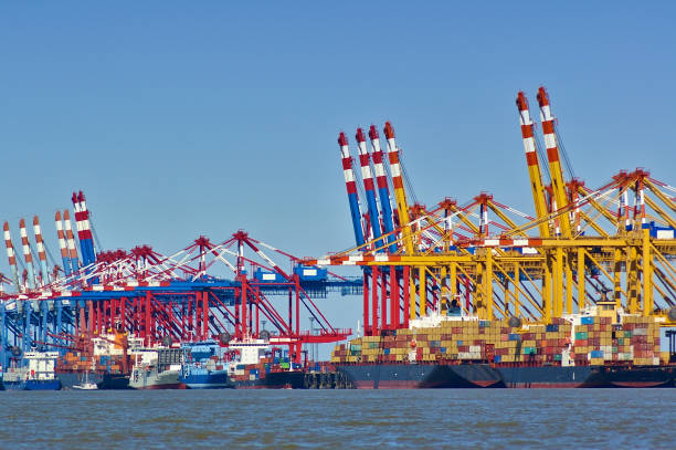 istock Colorful port facilities with cranes, containers and freight ships 680757570