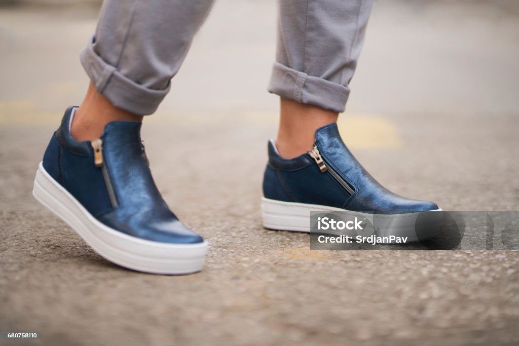 Comfy Steps Close-up shot of a woman's feet wearing modern leather shoes. Leather Stock Photo