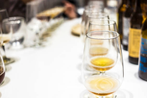 istock Many blond beers in wineglasses on a white table 680759106