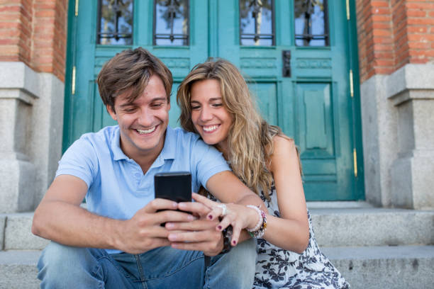 istock attractive couple looking at the phone 680765118
