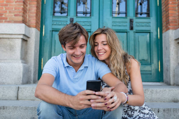 istock attractive couple looking at the phone 680765122