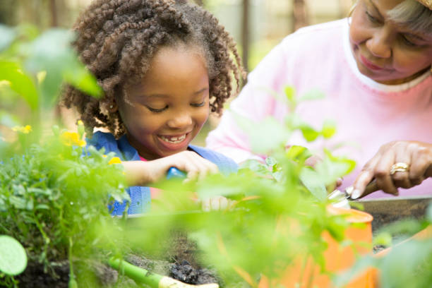 istock Grandmother and child gardening outdoors in spring. 680765256