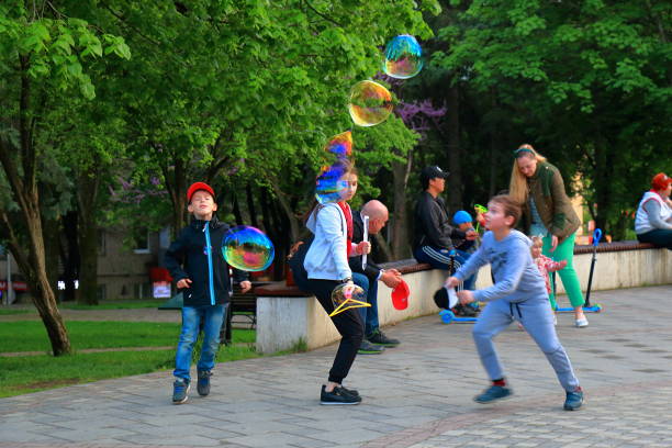 Pyatigorsk, Russia - May 8, 2017: Evening. Children play with soap bubbles on Lenin Square in Pyatigorsk, Russia