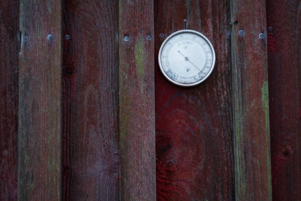 Barometer covered in frost Cold barometer on a barn wall metcast stock pictures, royalty-free photos & images