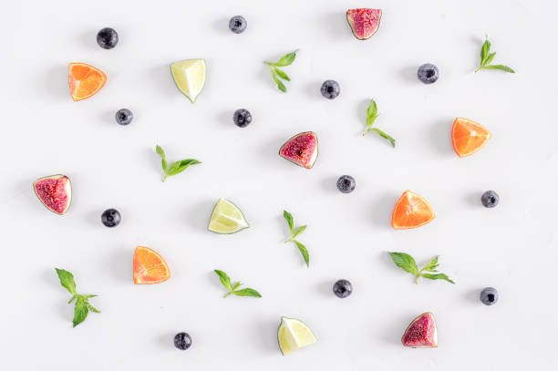 istock cut fruit pattern with blueberry and lavender on white desk background top view 680784390