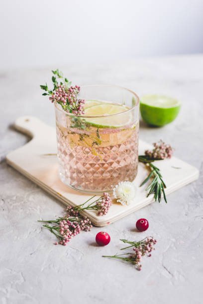 istock making cocktails in glasses with lime and berries on stone kitchen desk background 680784714