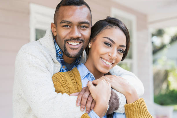 istock Affectionate young mixed race couple on front porch 680789196