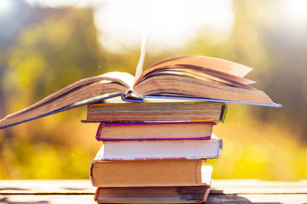 istock Open book on wooden table on natural background. Soft focus 680789416