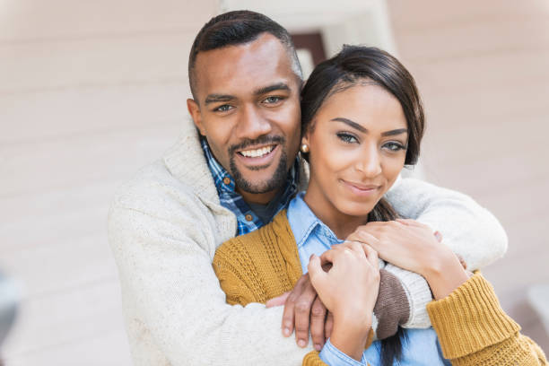istock Affectionate young mixed race couple on front porch 680789454