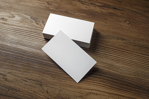 Blank white bussiness cards on wood background. Mockup for ID. Blank template for promotion of corporate identity.