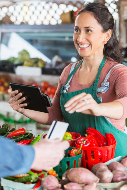 istock Worker at produce market processing credit card 680790058