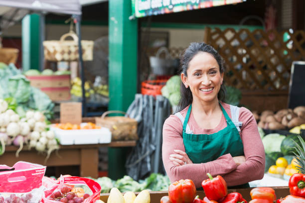 istock Hispanic woman working at fruit and vegetable stand 680790192