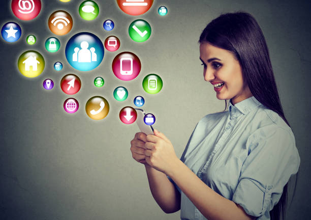 istock woman using smartphone with application icons flying out of screen 680793742