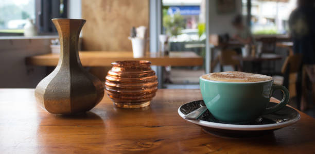 Hot cappuccino on a table inside a coffee shop.