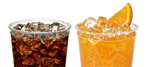 Cola and orange juice in take away cups with crushed ice on white background